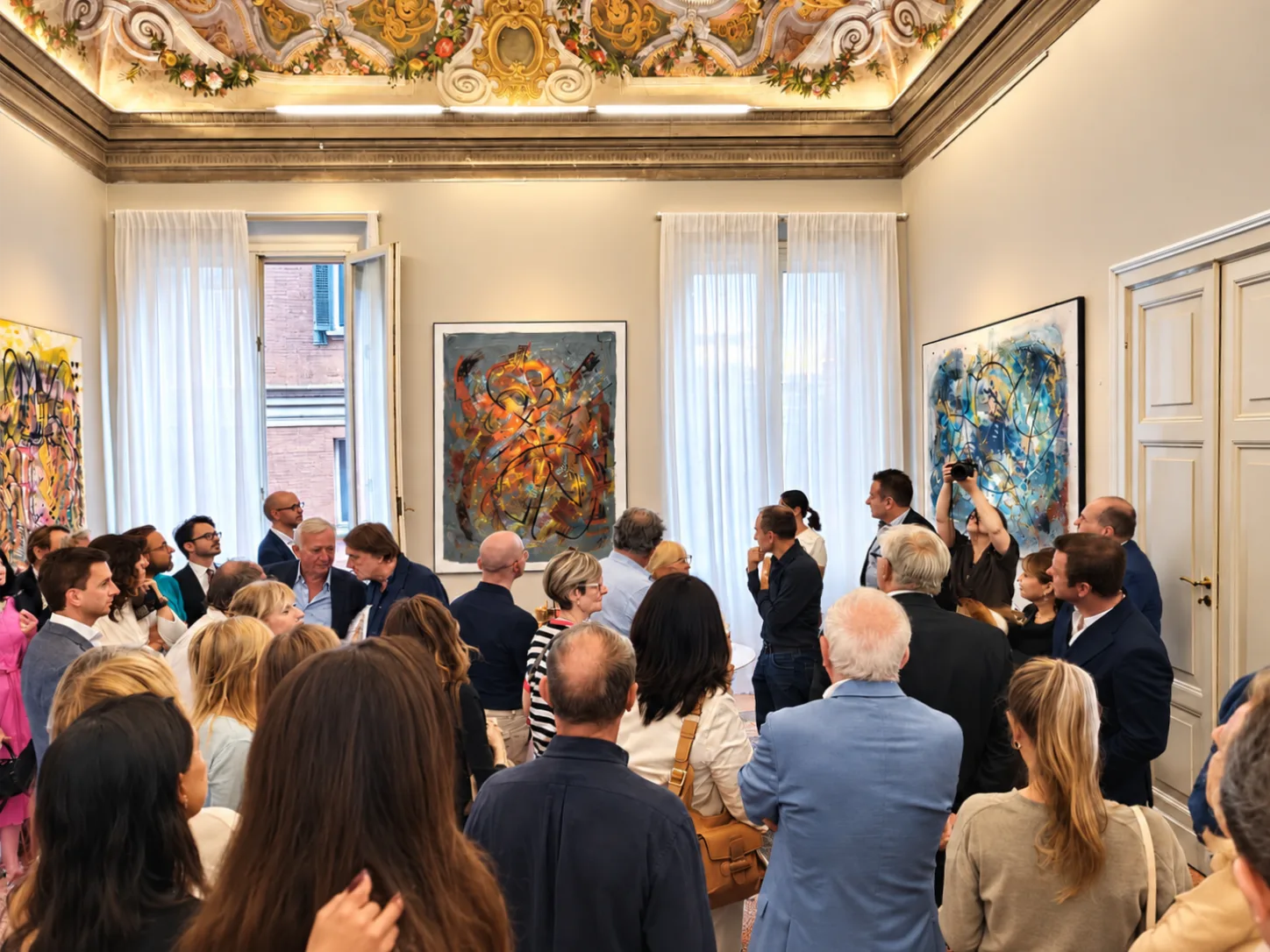 Visitors and works by Matteo Ferretti in an exhibition setting